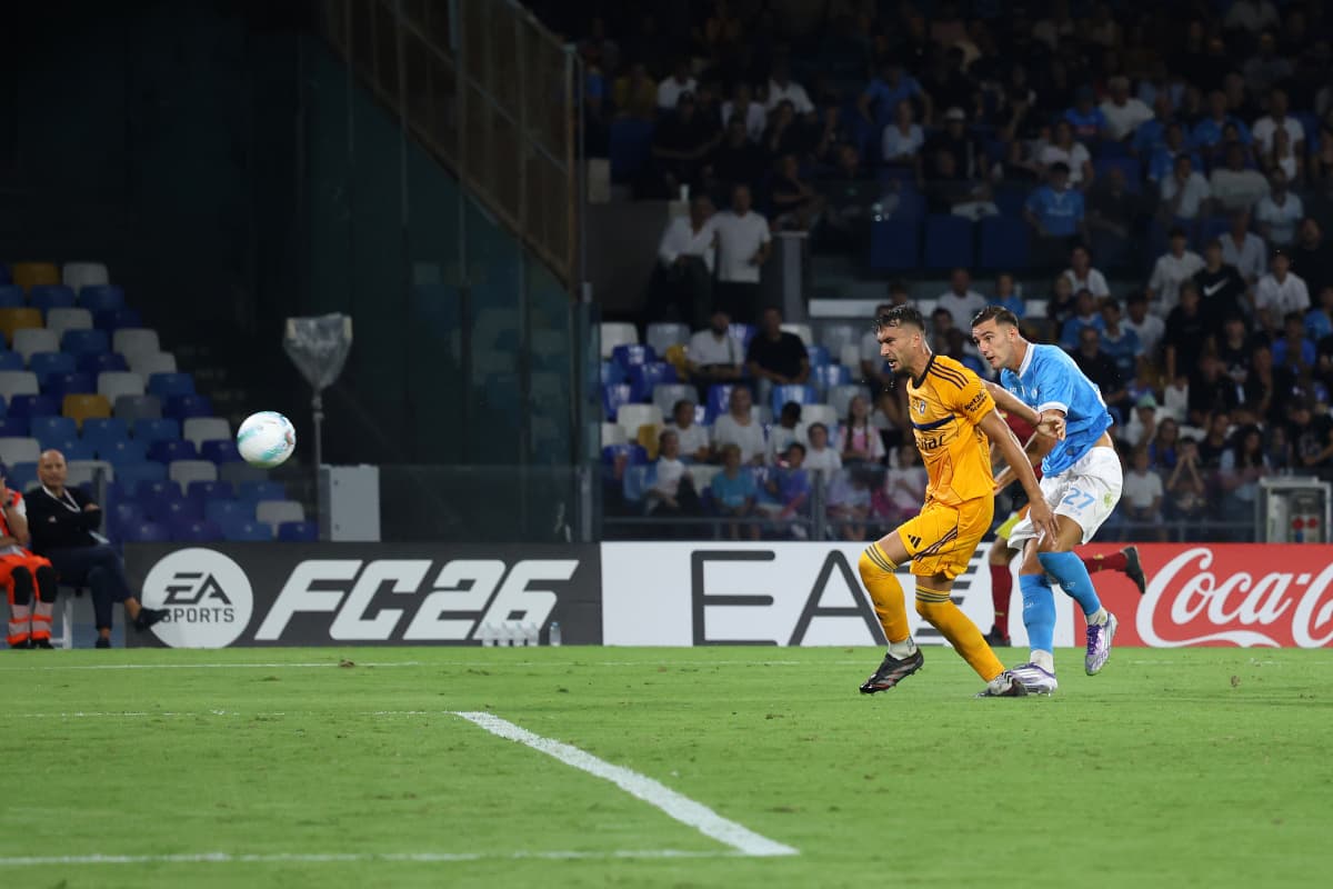 Pisa player challenged by Napoli during match