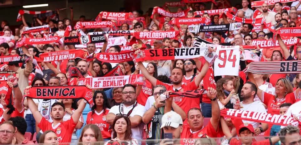 Benfica fans holding scarves in the stadium