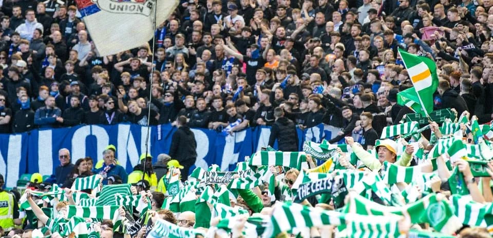 Fans waving scarves in a football stadium