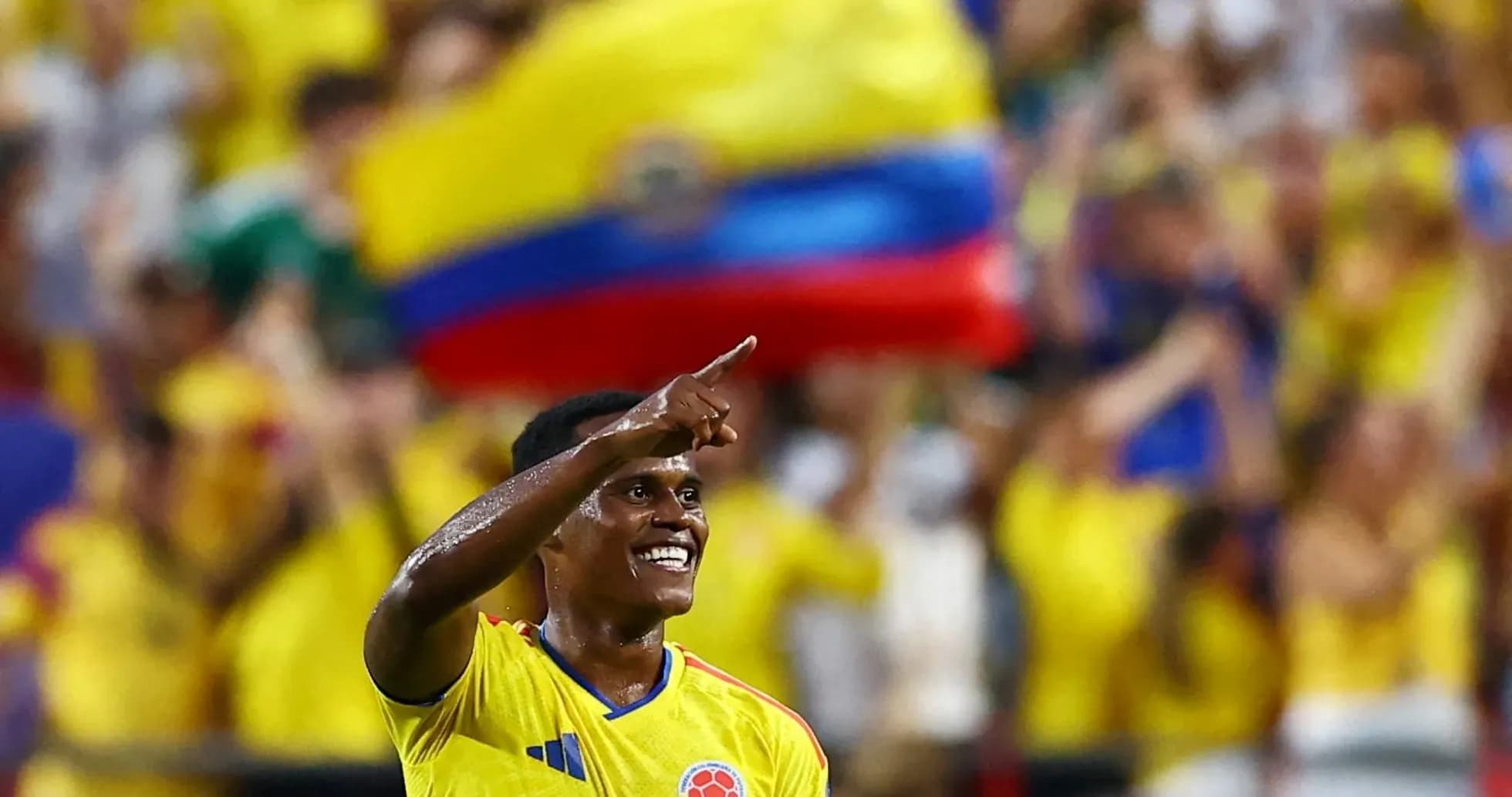 Player celebrating a goal with fans in background