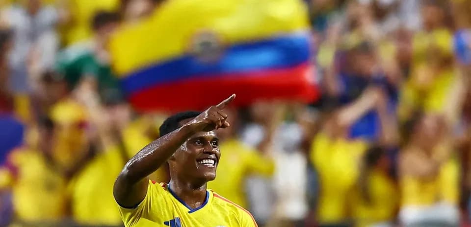 Player celebrating a goal with fans in background