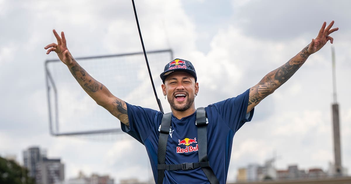 Neymar celebrating with arms raised in outdoor setting