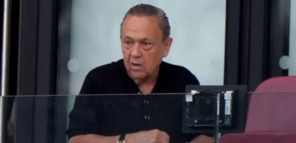 Man observing from a stadium box during event