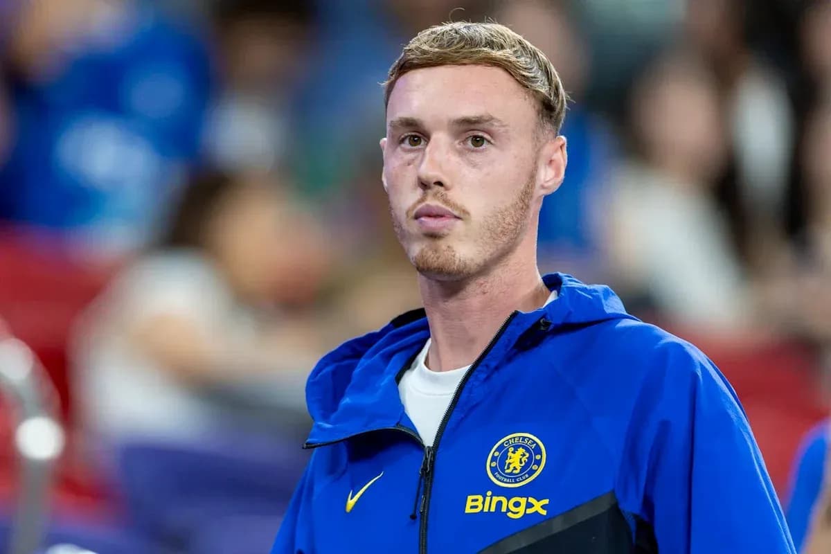 Chelsea player in blue jacket on sidelines
