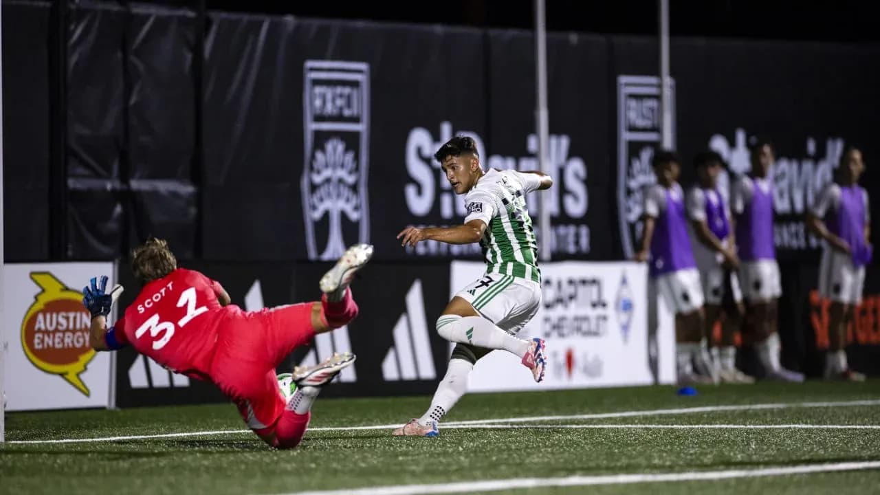 Player attempting to score against goalkeeper in match