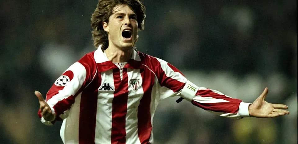Player celebrating with arms raised in stadium