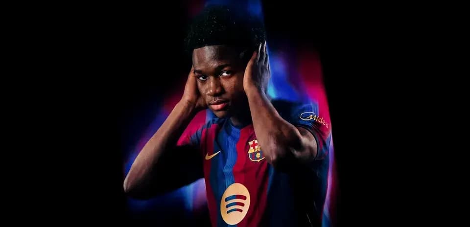 Player in Barcelona jersey with hands on head