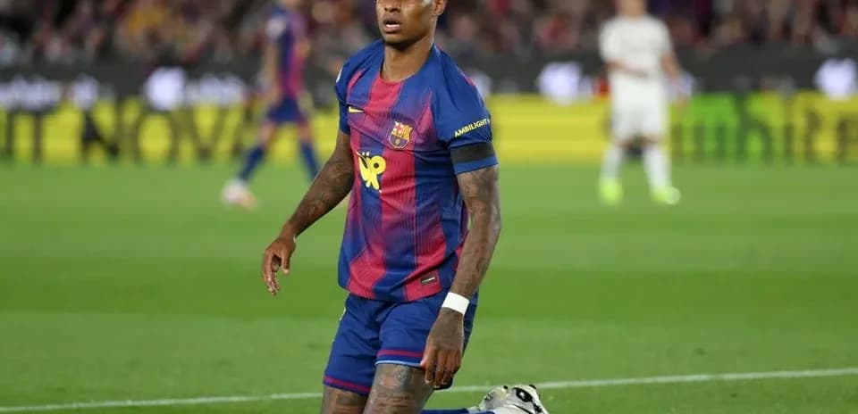 Barcelona player kneeling on the pitch during match