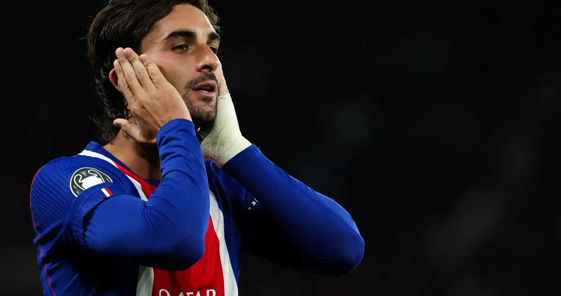 Player holding his face in football match