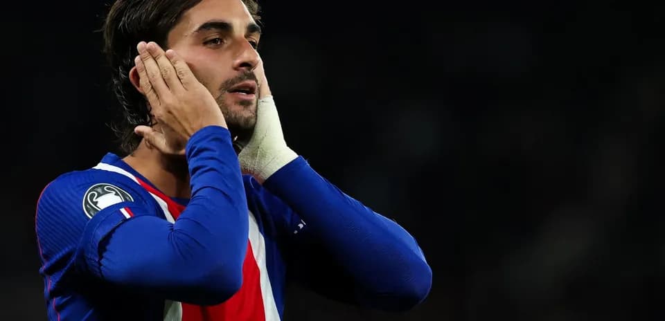 Player holding his face in football match
