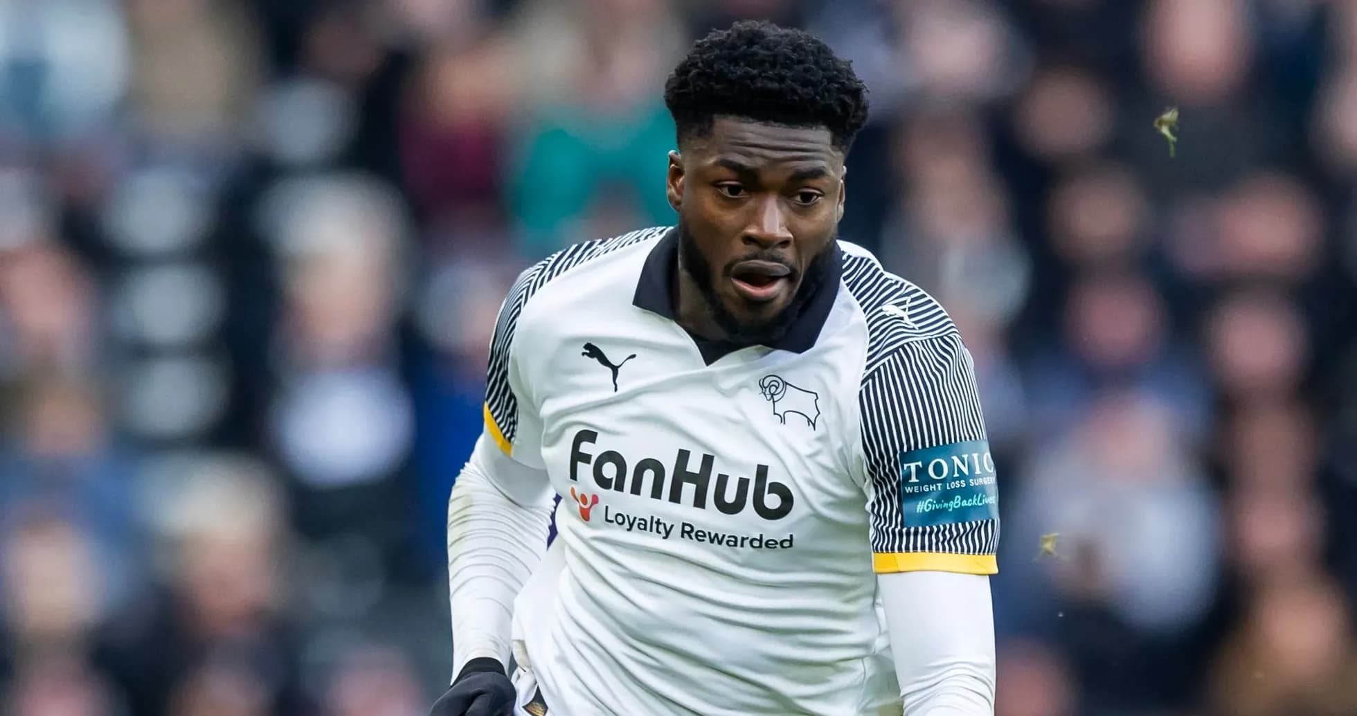 Player in white jersey running during match