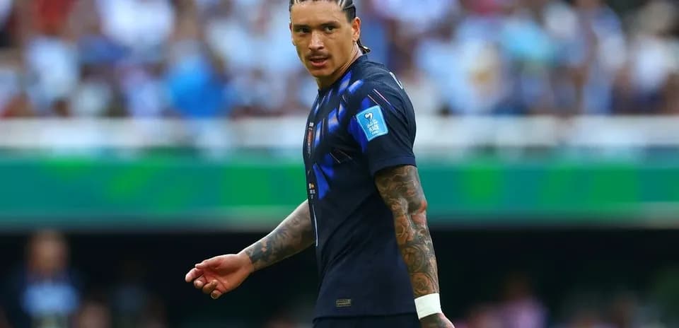 Player in dark jersey walking on the field