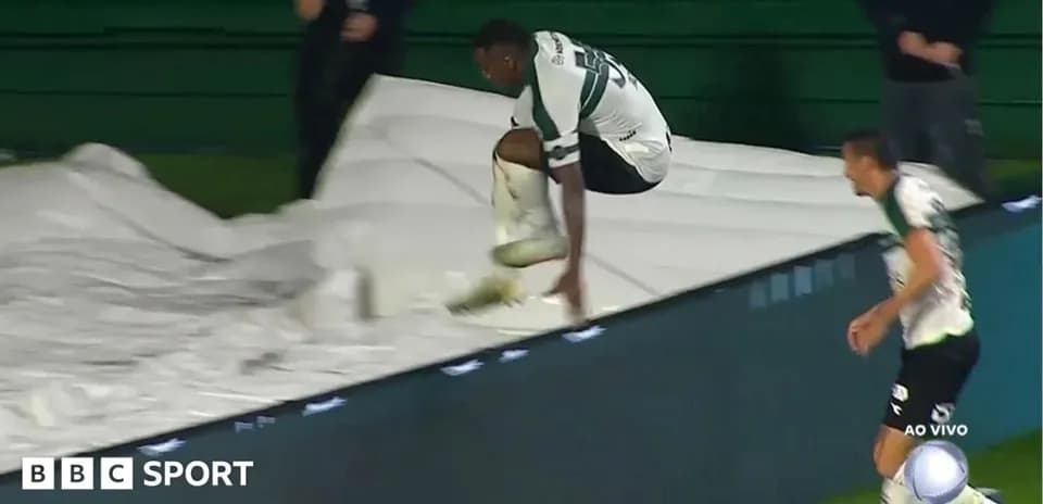 Player jumping over a barrier during match celebration