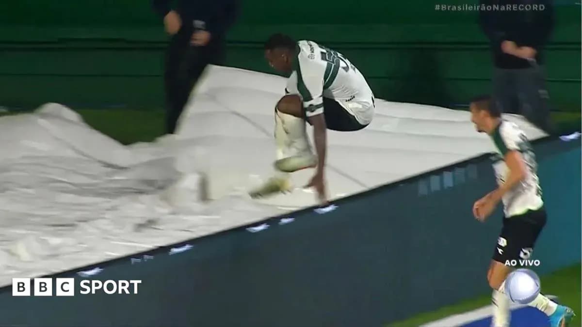 Player jumping over a barrier during match celebration