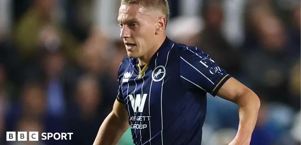 Player in blue kit running on the field