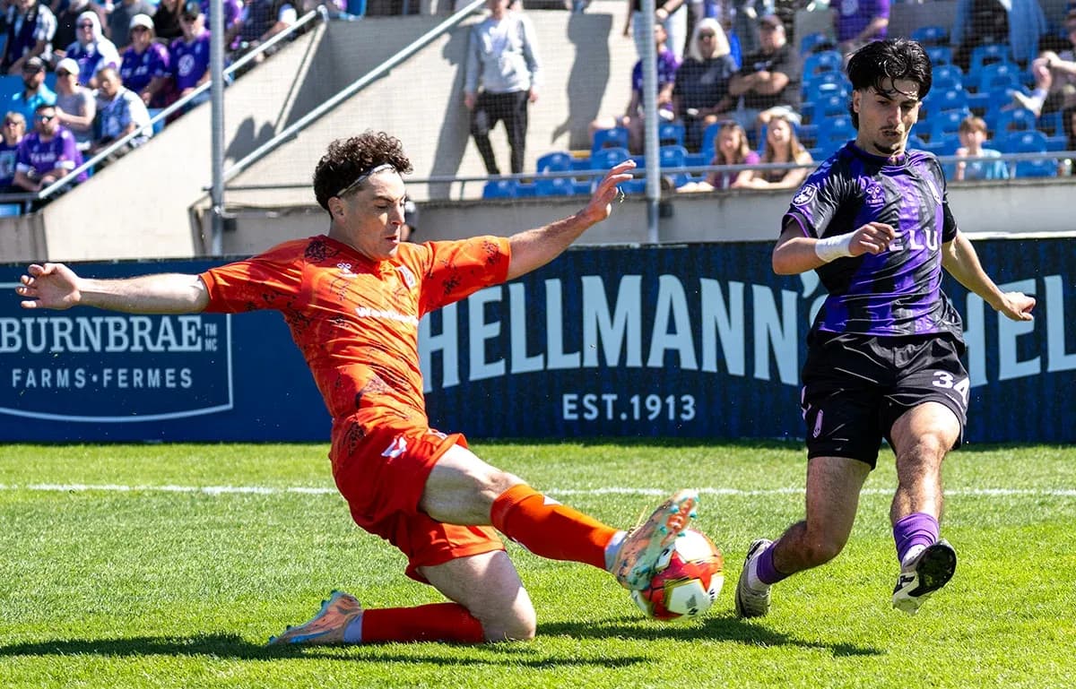Player tackling opponent during Forge vs Pacific FC match