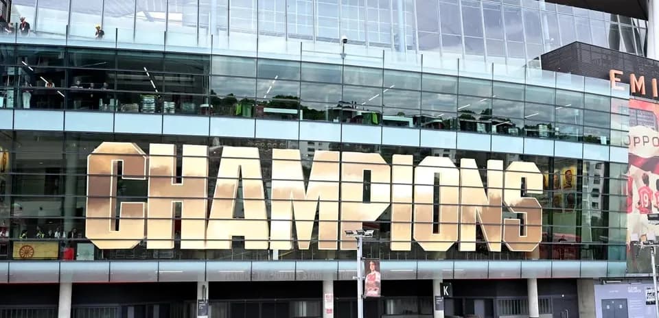Exterior of stadium with 'CHAMPIONS' displayed prominently