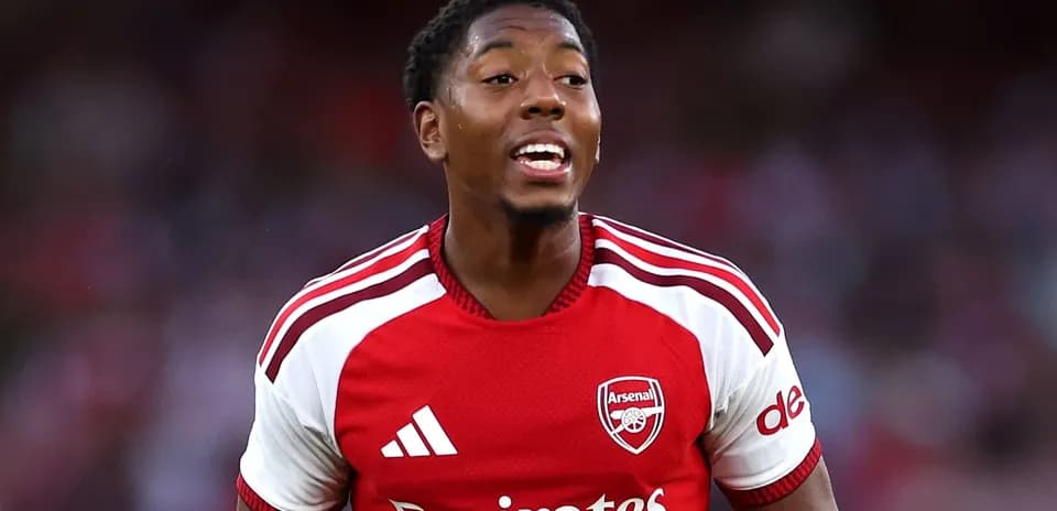 Player celebrating wearing Arsenal jersey during match