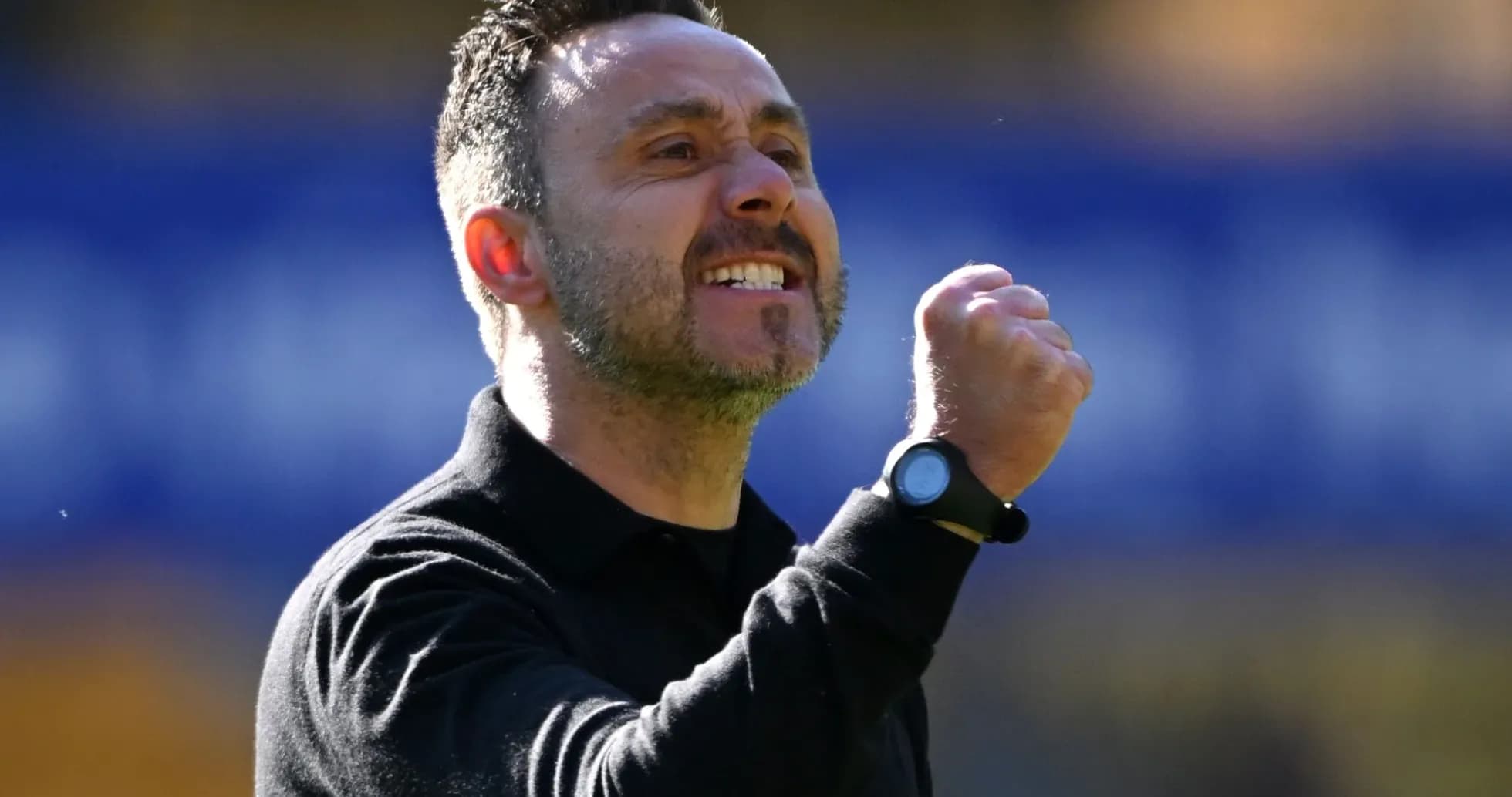Coach celebrating with clenched fist during match