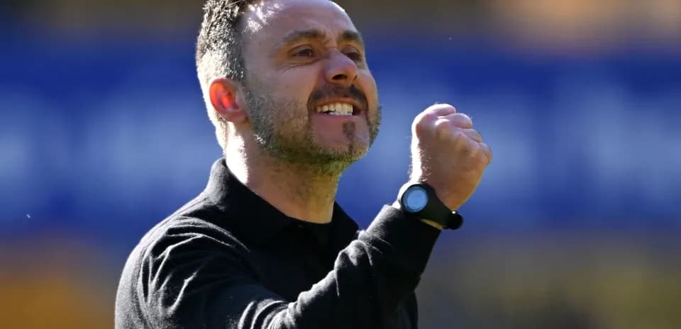 Coach celebrating with clenched fist during match