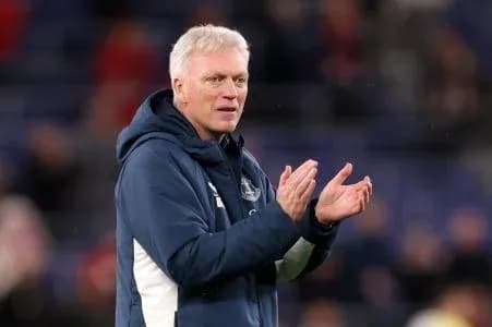 Manager applauding from the sidelines during match
