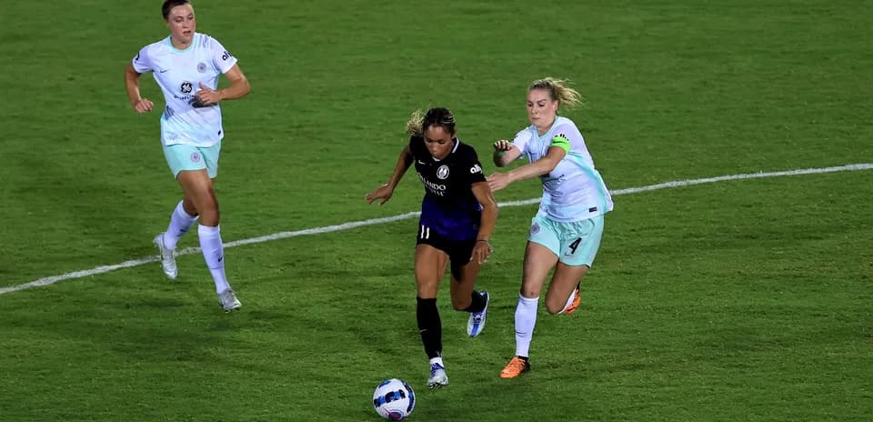 Player dribbling the ball in NWSL match