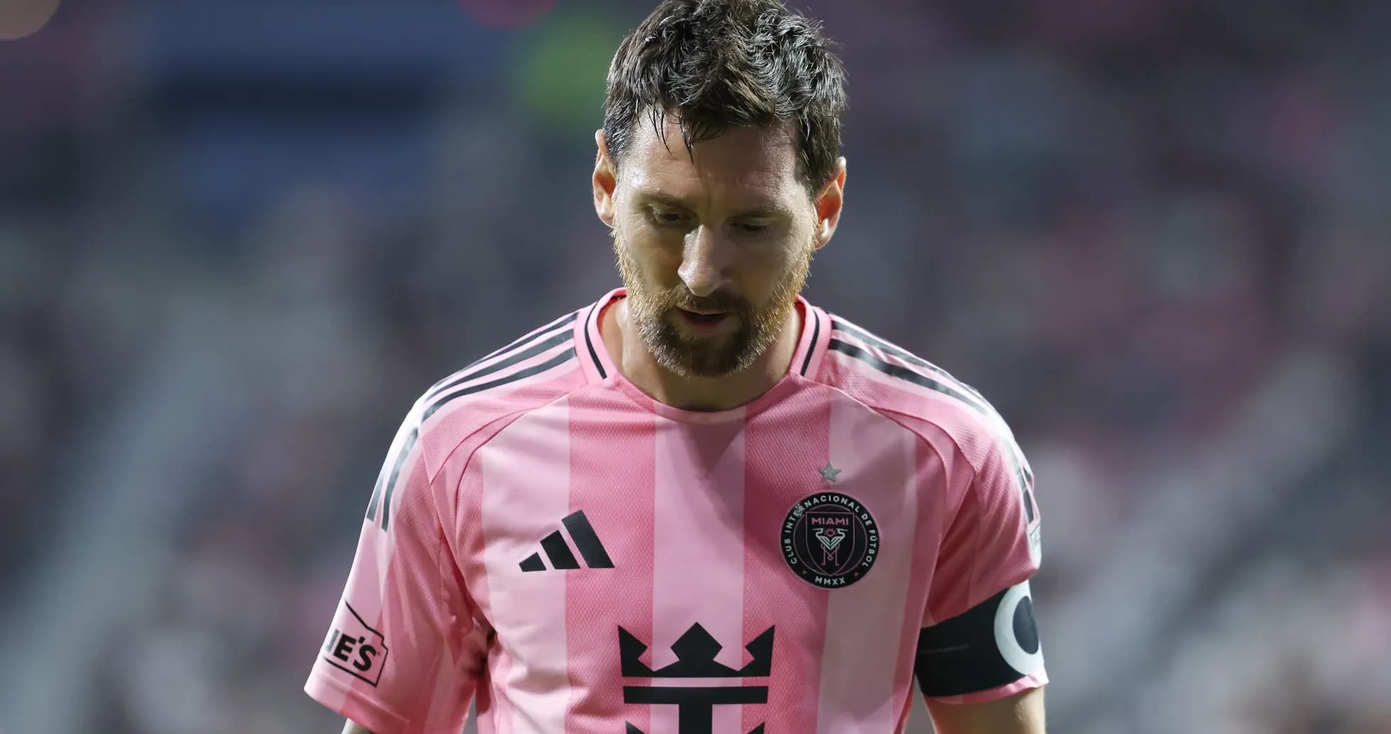 Player in pink jersey walking on the field