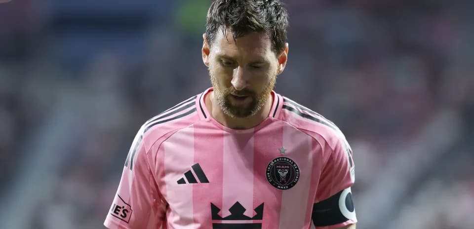 Player in pink jersey walking on the field
