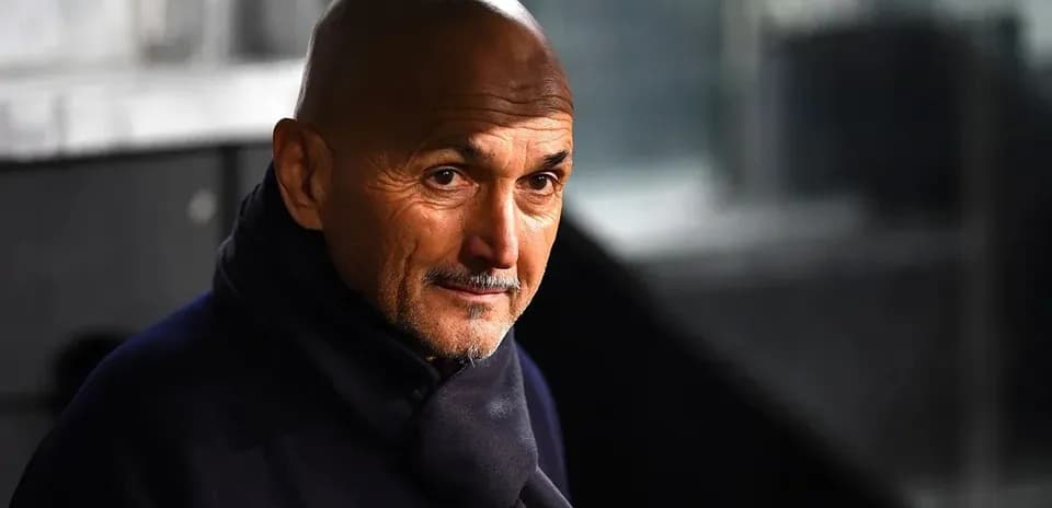Coach wearing a dark coat in a stadium