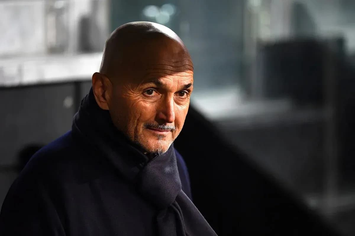Coach wearing a dark coat in a stadium