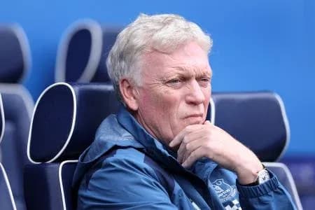 Manager deep in thought on the bench