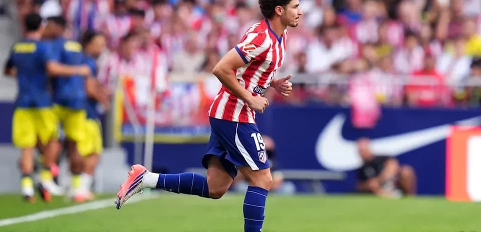 Atletico Madrid player running on the field