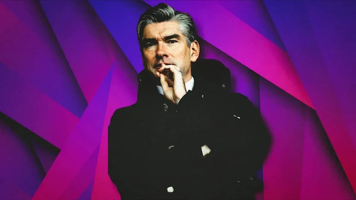 Person in a black coat against a colorful background