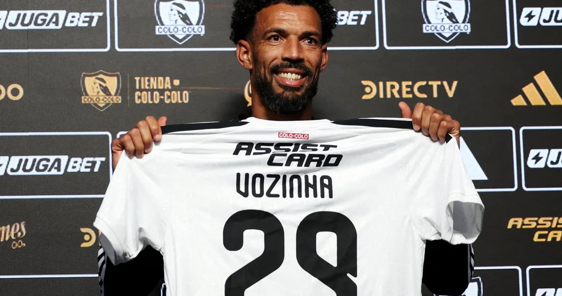 Player holding Colo-Colo jersey at presentation event