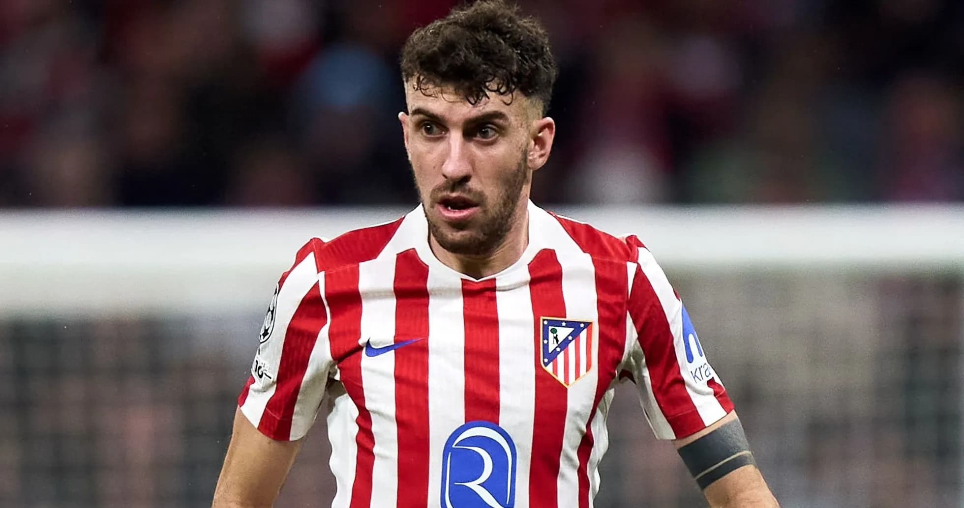 Atletico Madrid player in red and white striped jersey