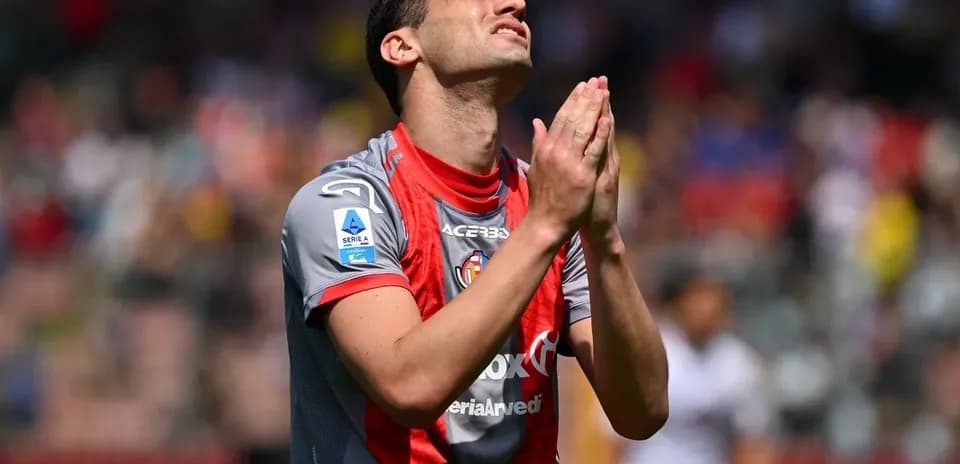 Player with hands clasped in front of face