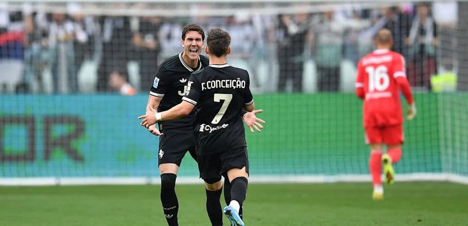 Two players celebrating a goal on the field