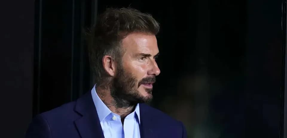 Man with beard and tattoos in a suit
