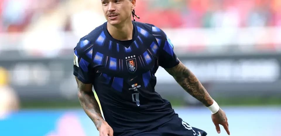 Player in blue kit running on the pitch