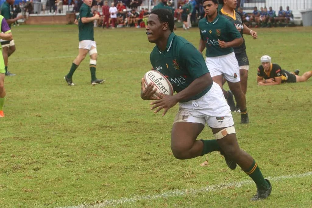 Player running with rugby ball during match