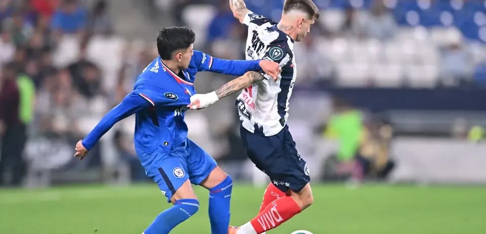 Monterrey player tackling Cruz Azul opponent
