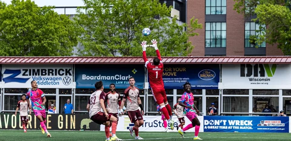 Goalkeeper making a save during football match
