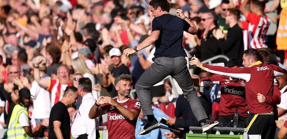 Celebration at stadium with fans and coaching staff