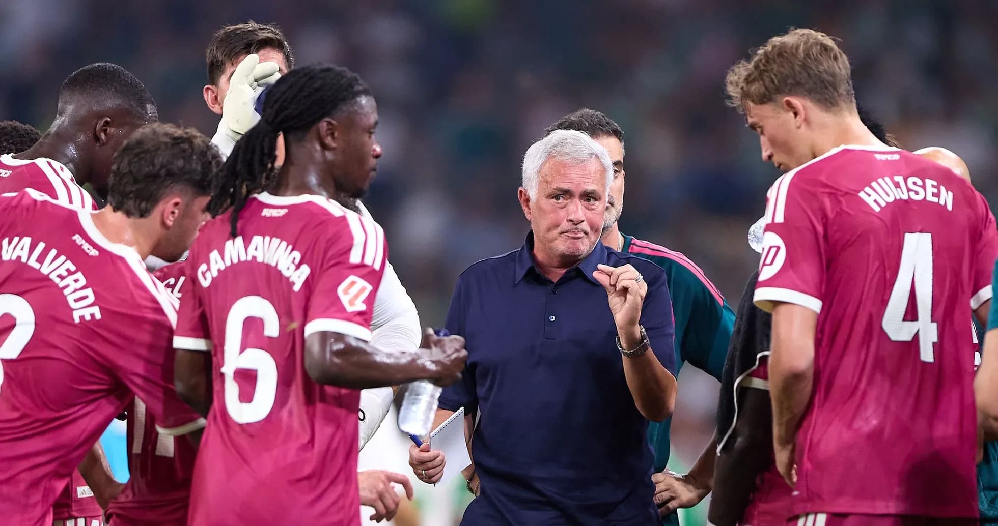 Manager discussing strategy with players during match