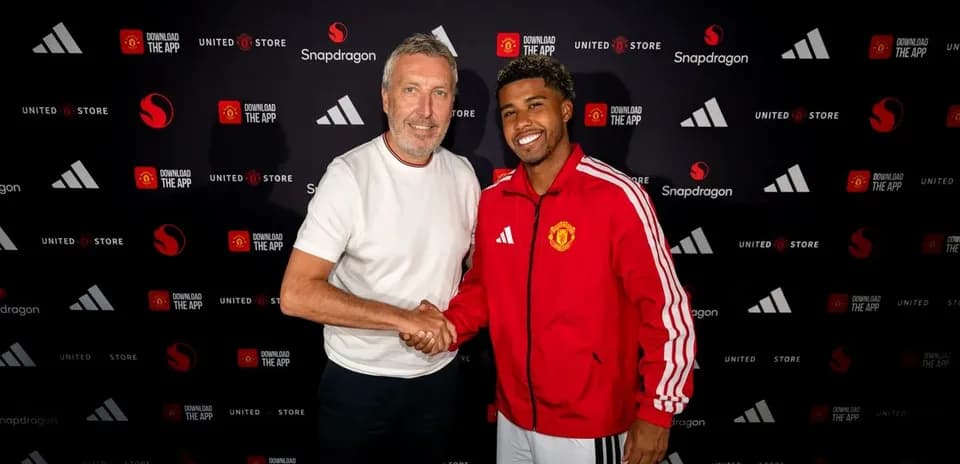 Player and representative shaking hands at signing event
