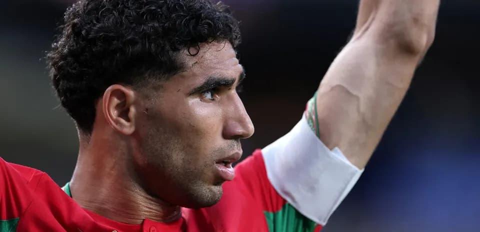 Player celebrating with raised arm in red jersey