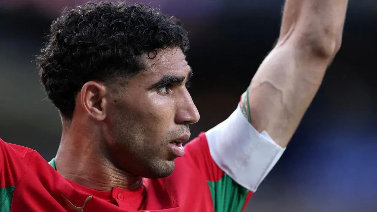Player celebrating with raised arm in red jersey