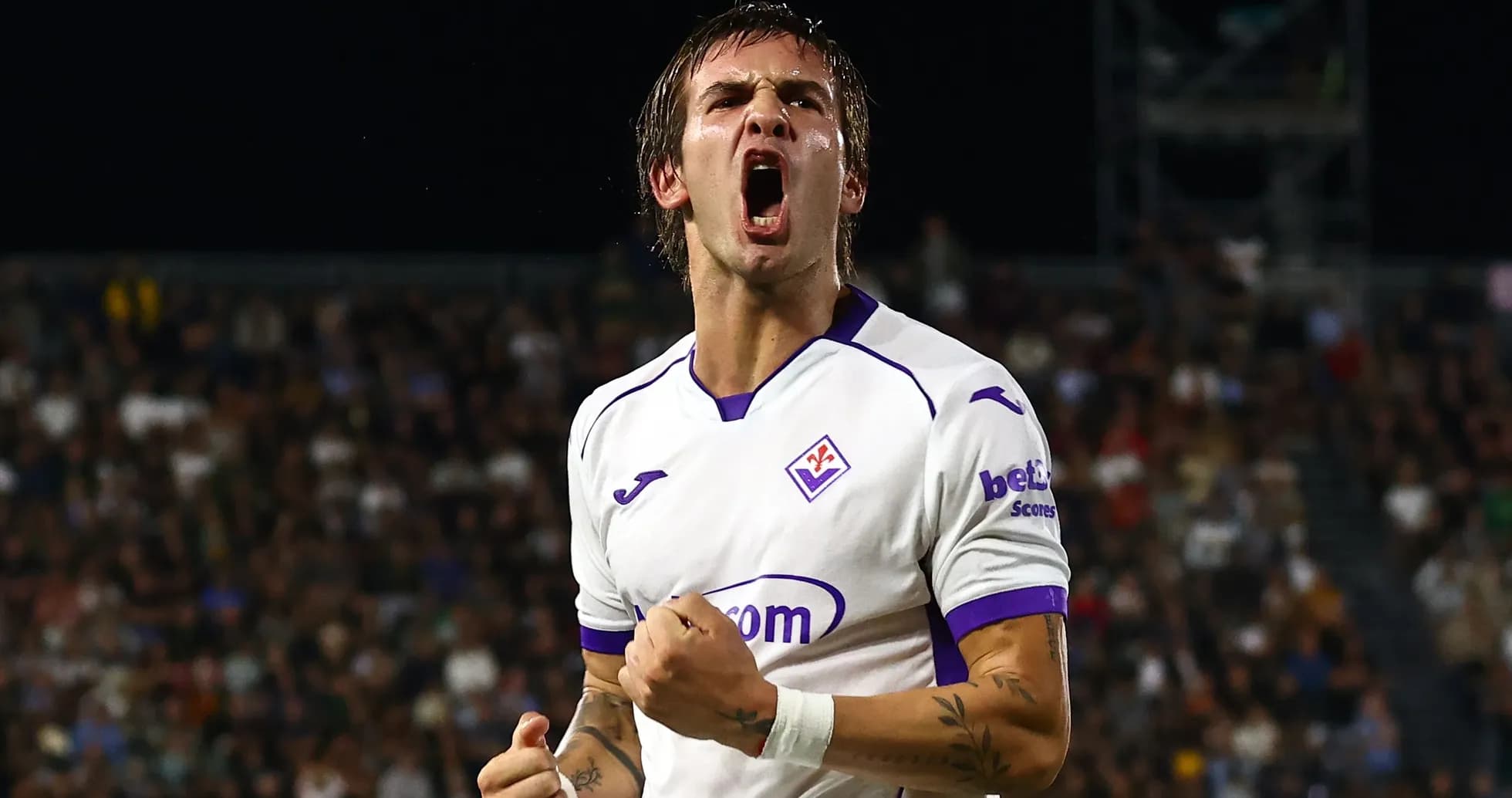 Fiorentina player celebrating a goal with clenched fist
