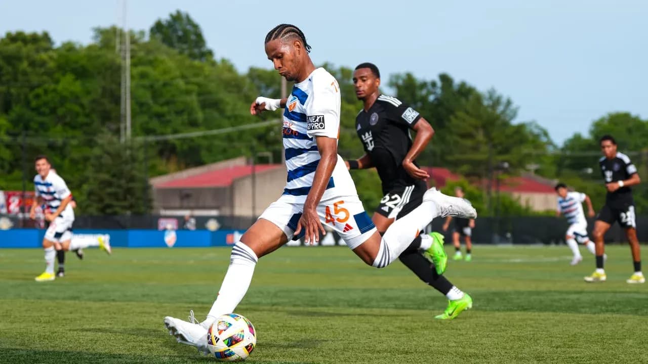 Player kicking ball during Huntsville City match