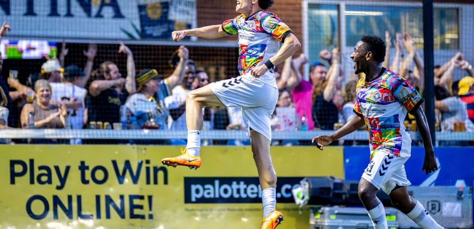 Player celebrating goal with teammates in match